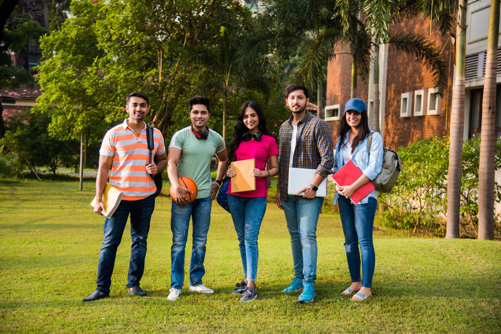 cheerful-indian-asian-young-group-college-students-friends-laughing-together-while-sitting-standing-walking-campus (1)